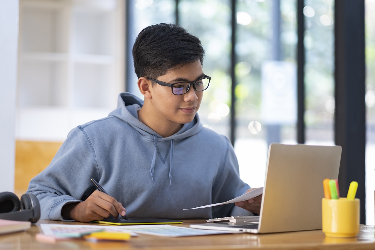 Teenager studying Spanish online with a laptop